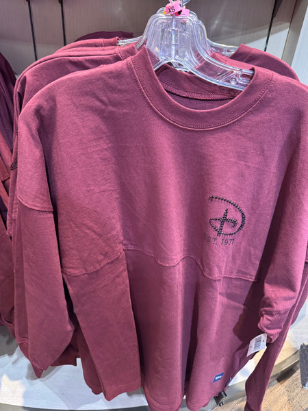 Maroon Spirit Jersey with WDW Disney logo on a hanger with a price tag.